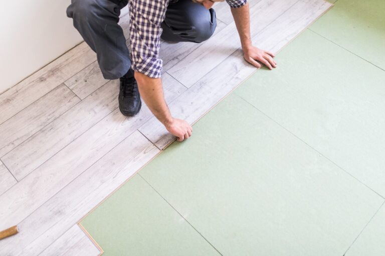 worker-processing-floor-with-bright-laminated-flooring-boards_231208-4213